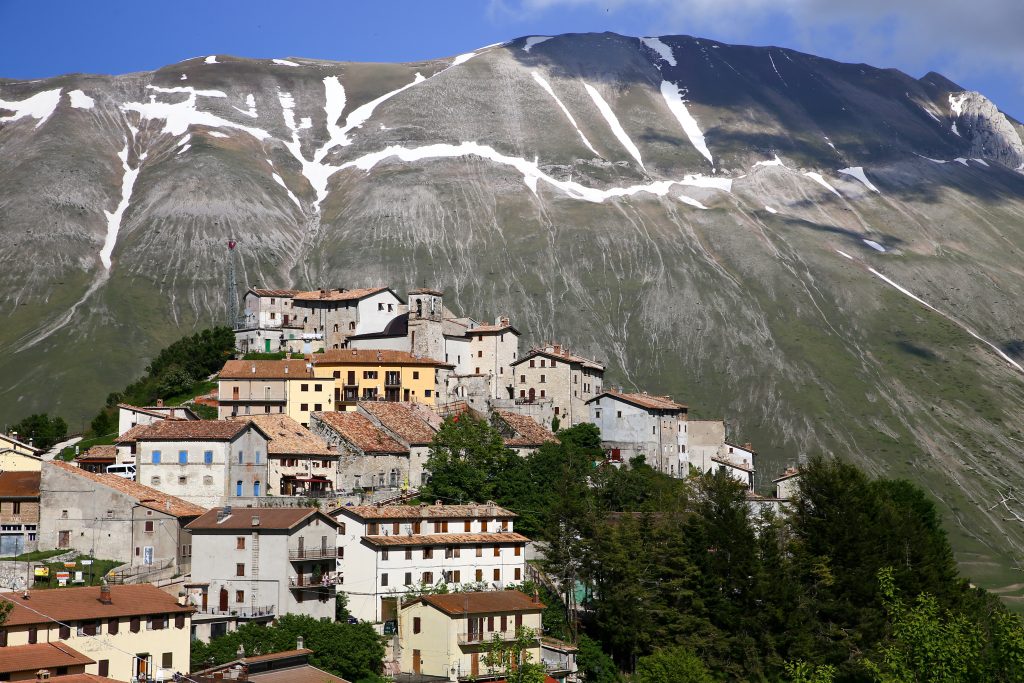 castelluccio di norcia with mountains behind